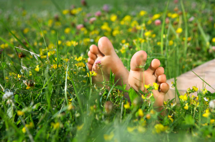 The beautiful feet lying on a lawn